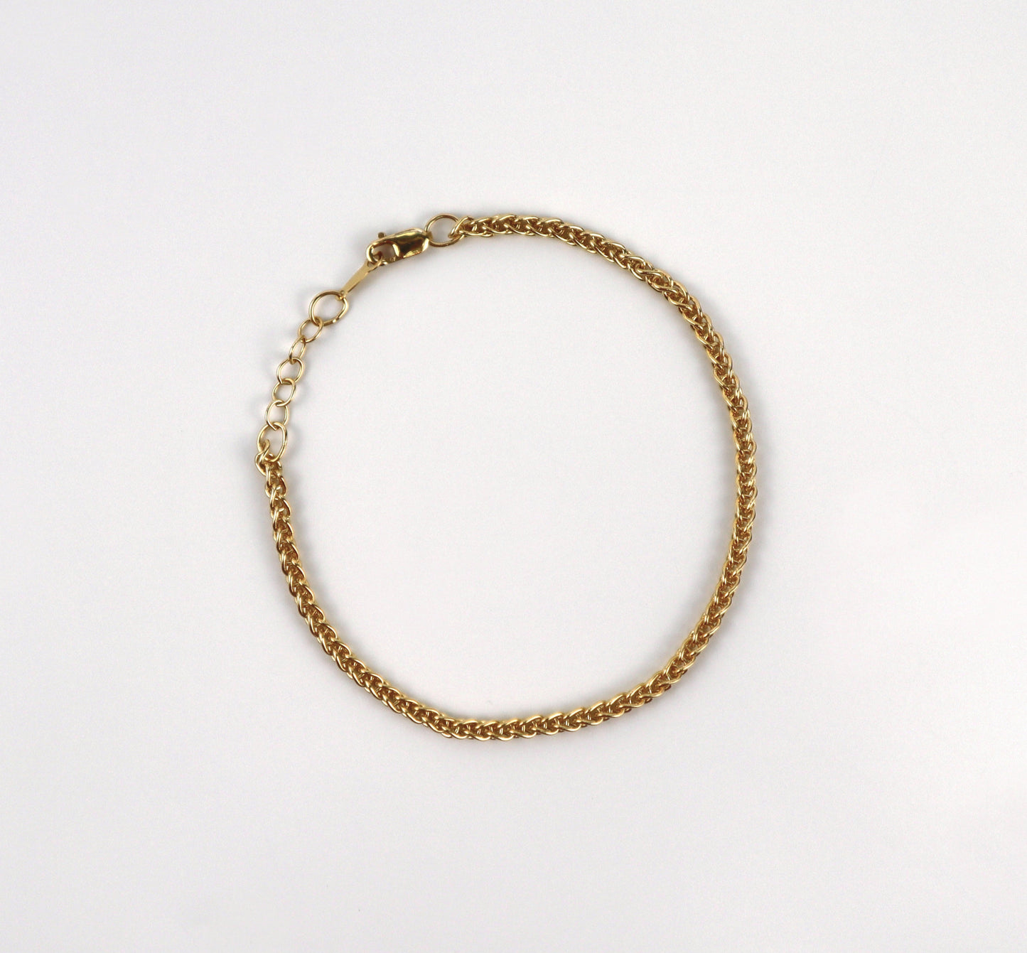 Gold chain bracelet on a white background