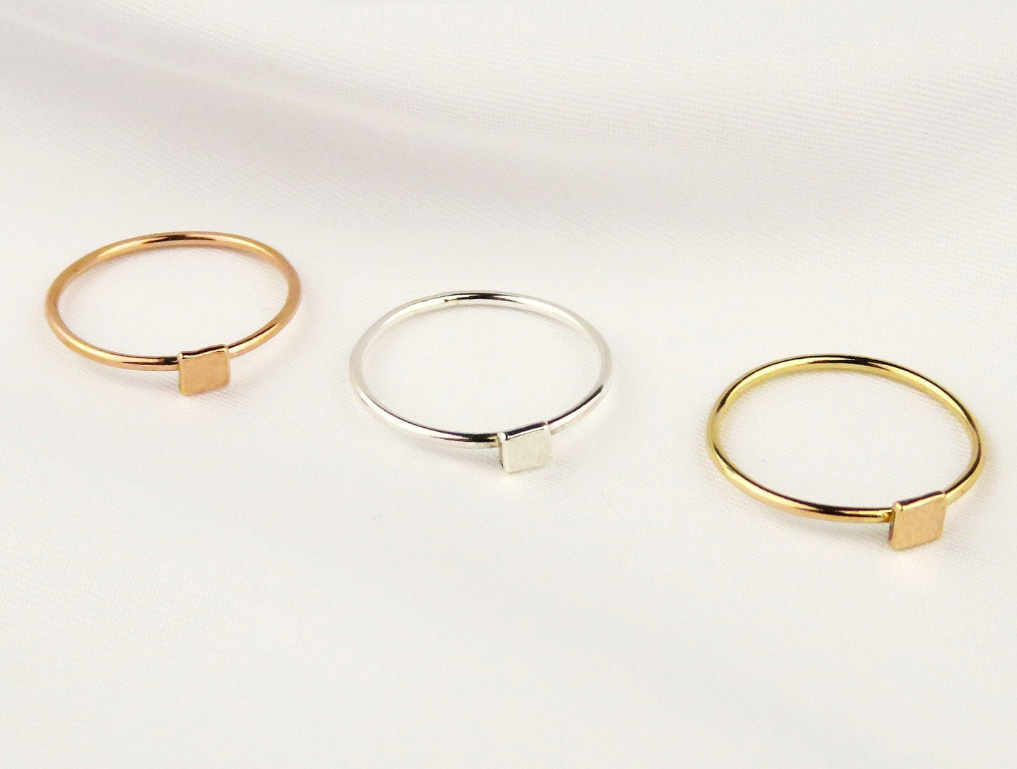 Three gold and silver rings on a white background