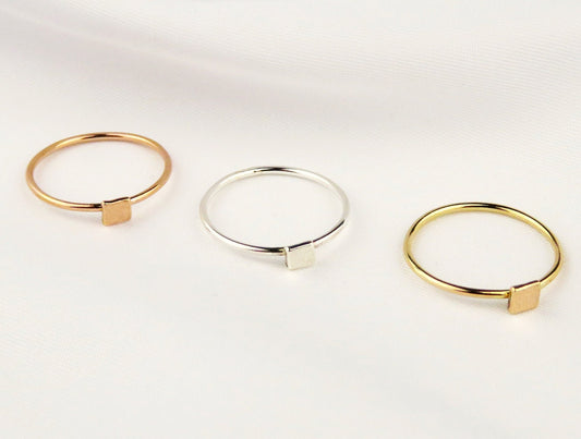 Three gold and silver rings on a white background