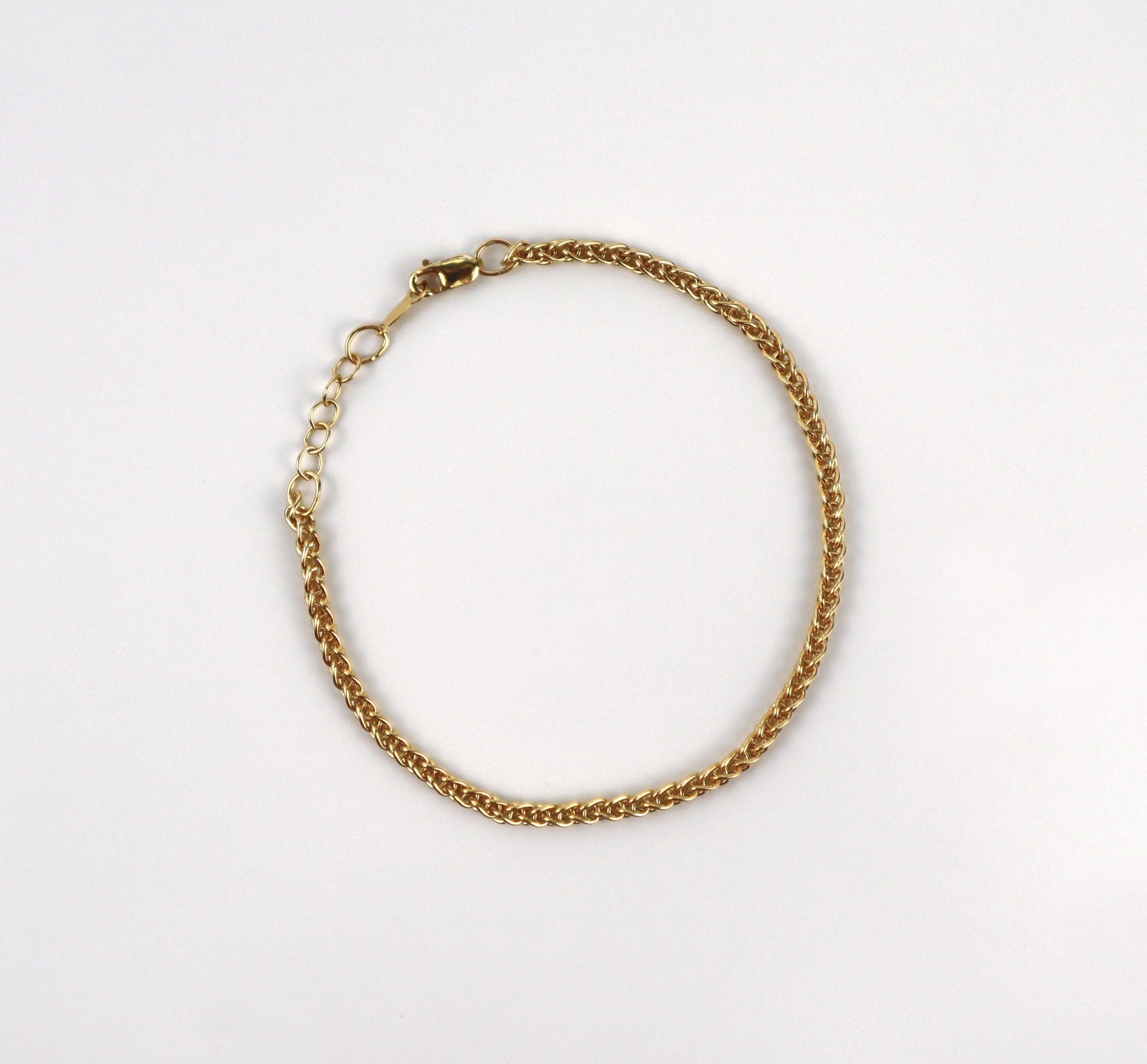 Gold chain bracelet on a white background