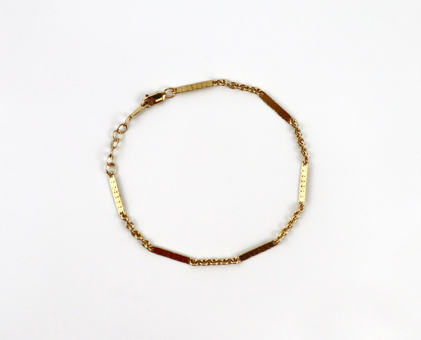 Gold bracelet on a white background