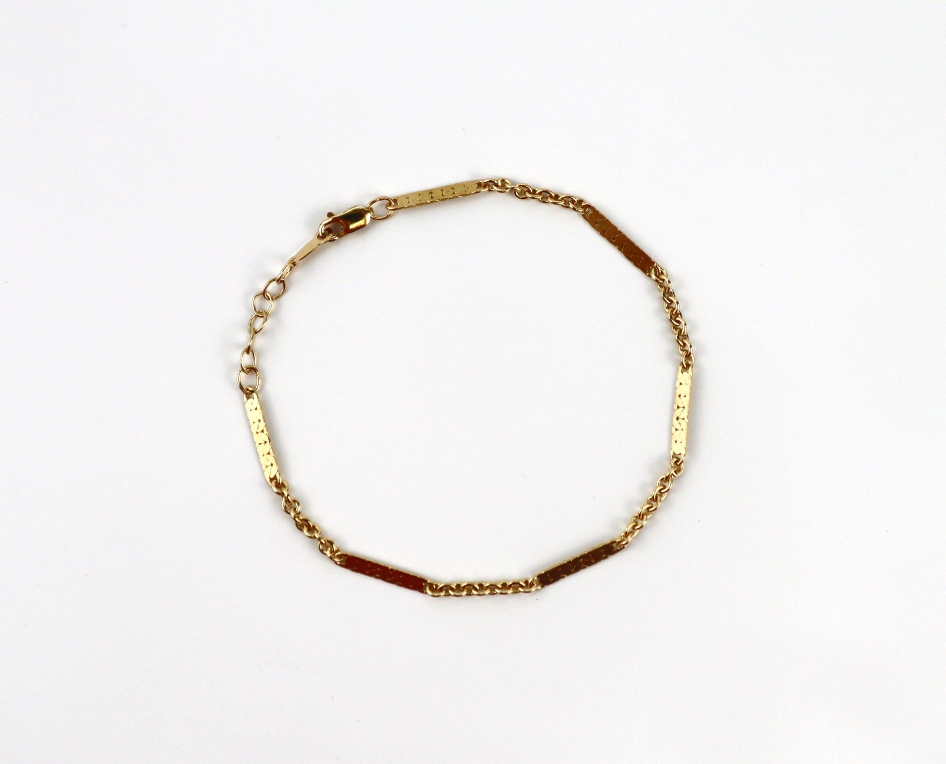 Gold bracelet on a white background